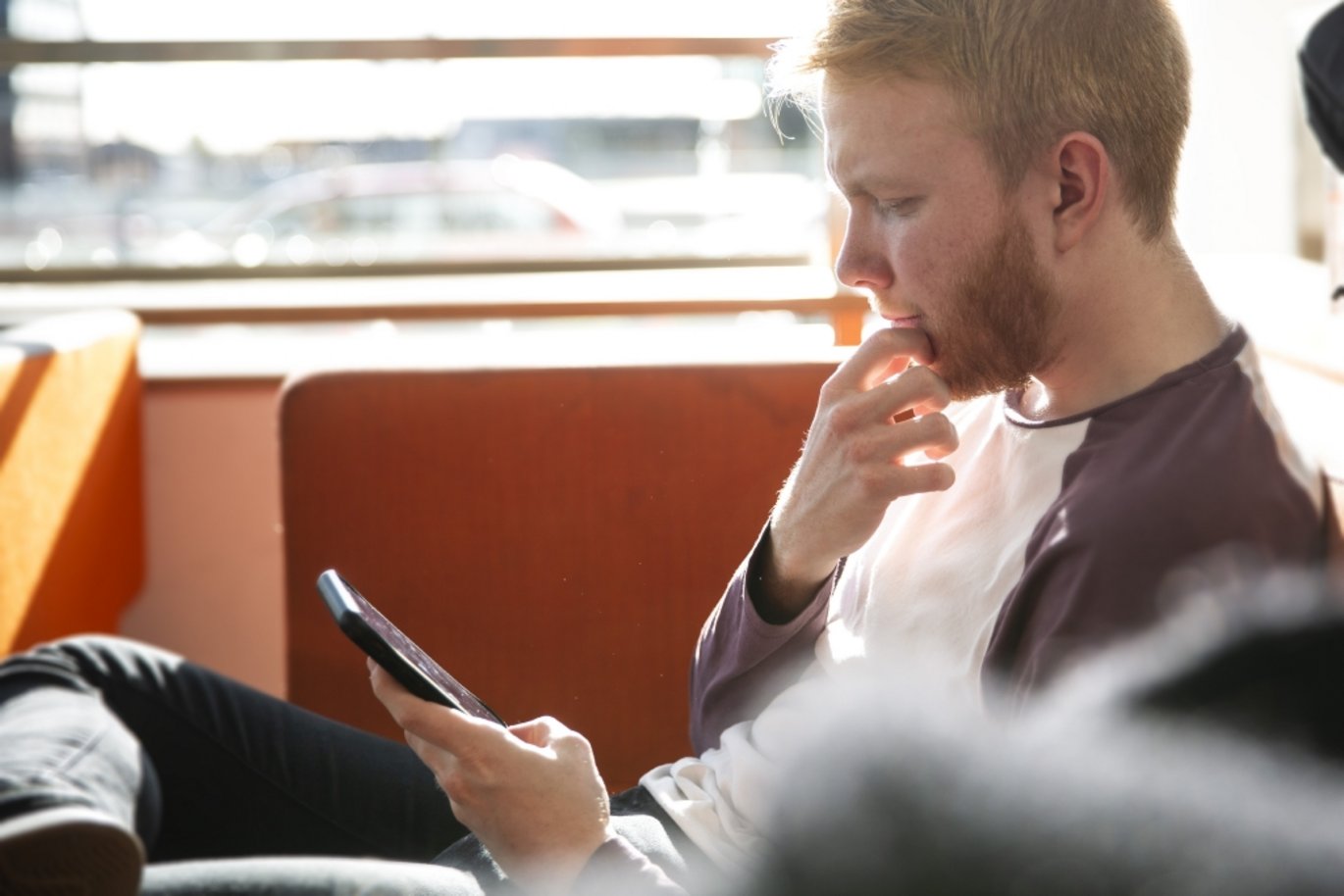 Person sitting with phone