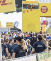 Many runners from Aarhus University stand ready to run among a large group of other runners at the DHL Relay Race.