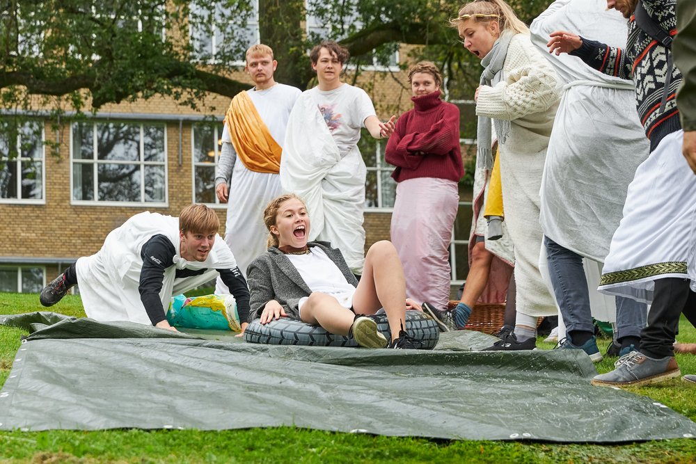 Students slide on tarp during introduction week at Aarhus University